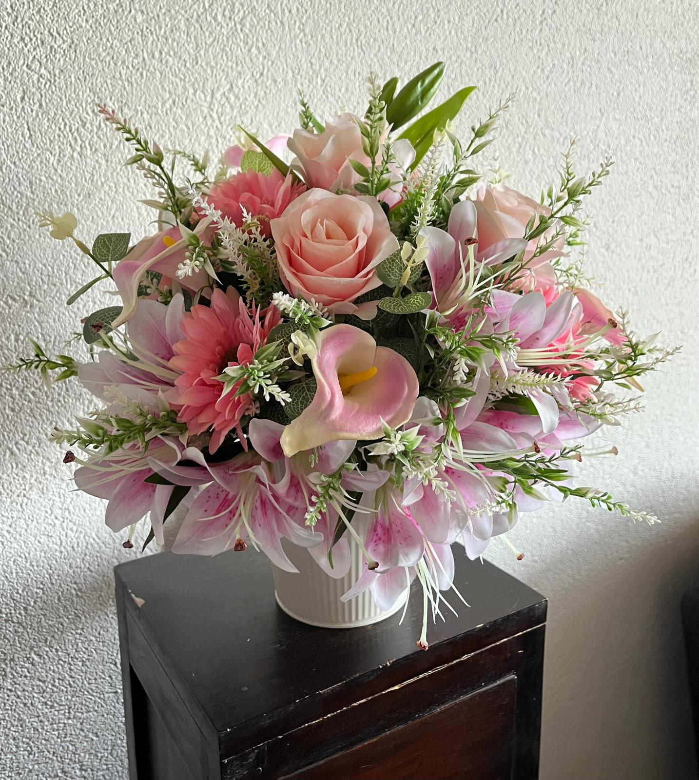 The hanging bucket with the pink lilies