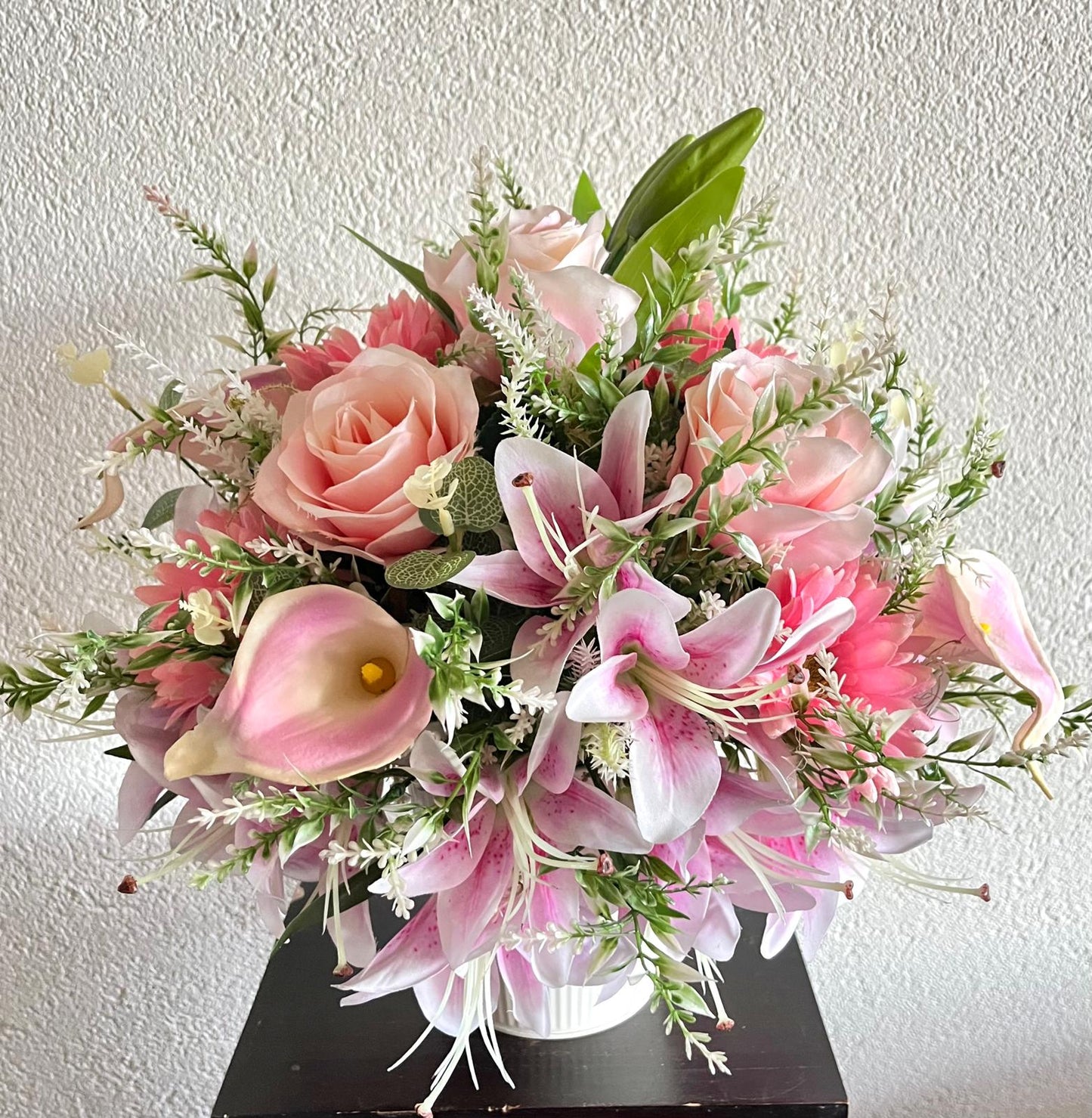 The hanging bucket with the pink lilies