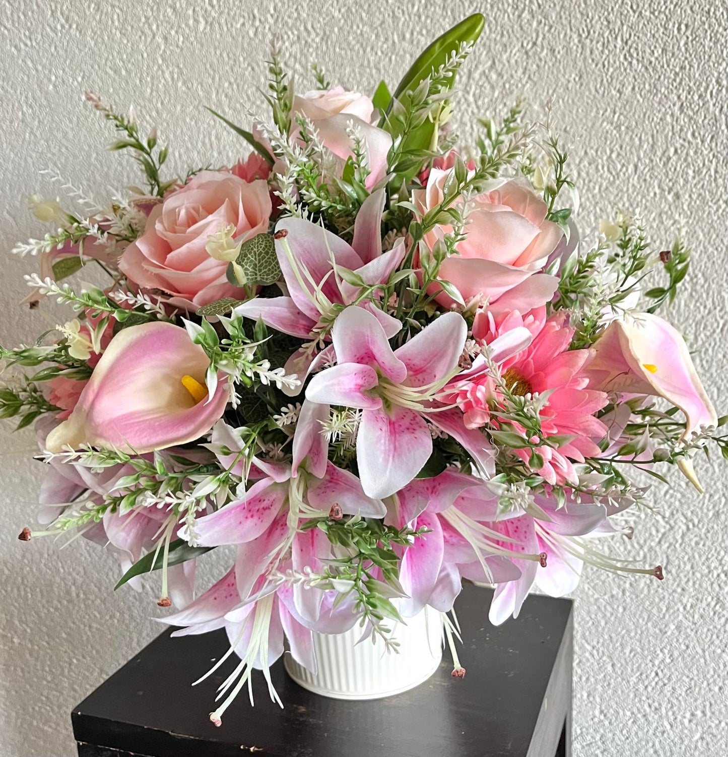 The hanging bucket with the pink lilies
