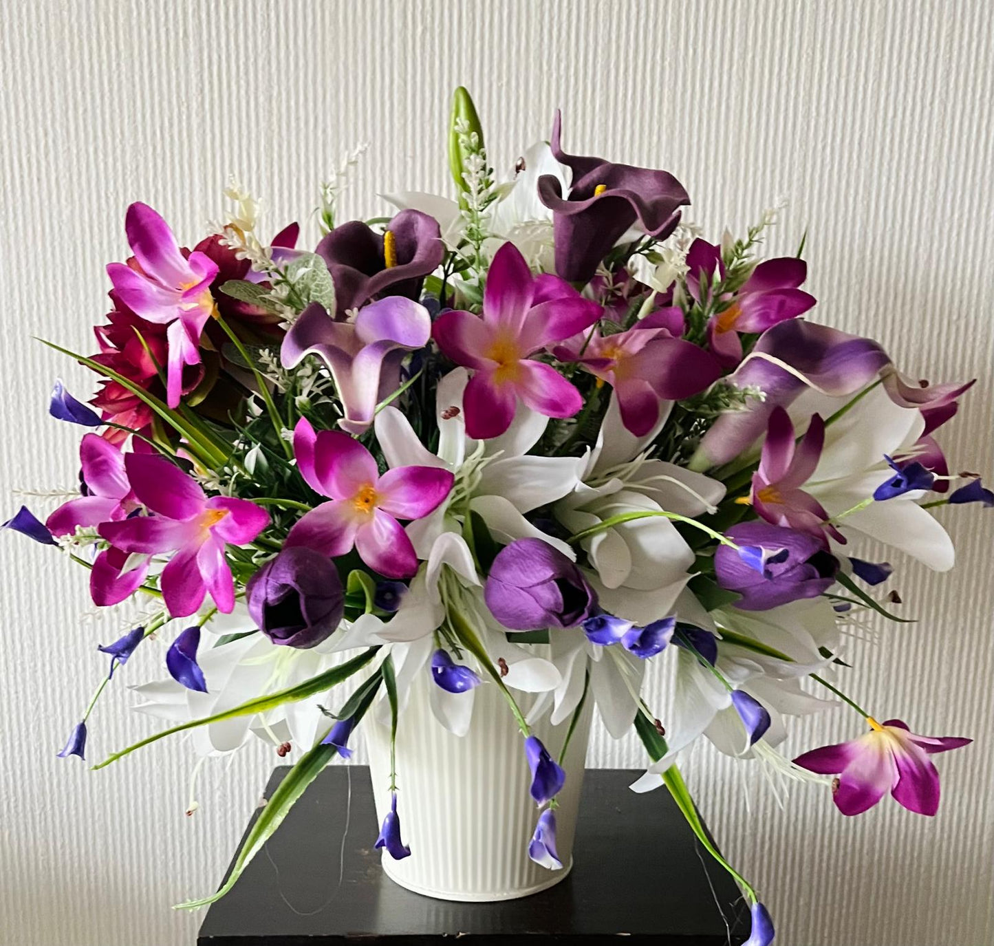 The hanging bucket with the purple lilies