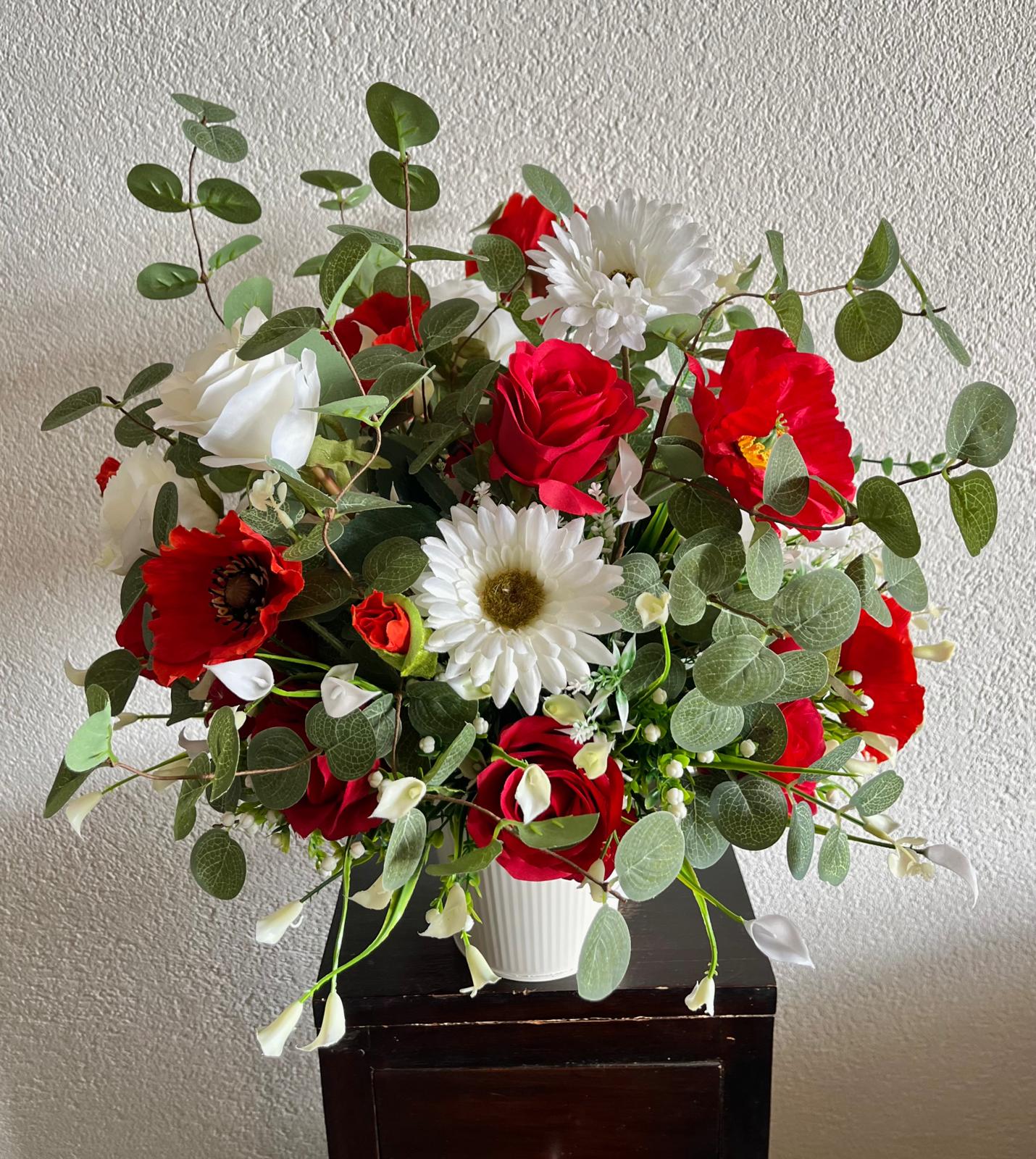The hanging bucket with the red flowers