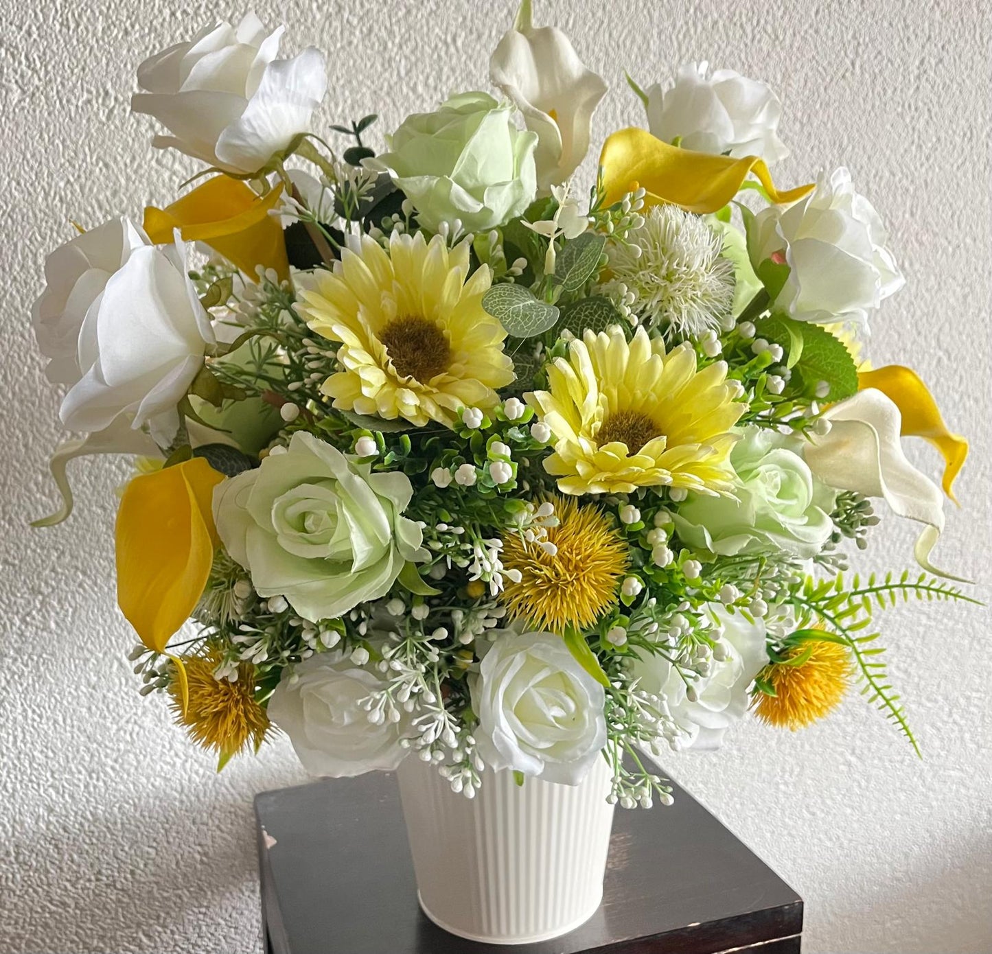 The hanging bucket with the yellow flowers