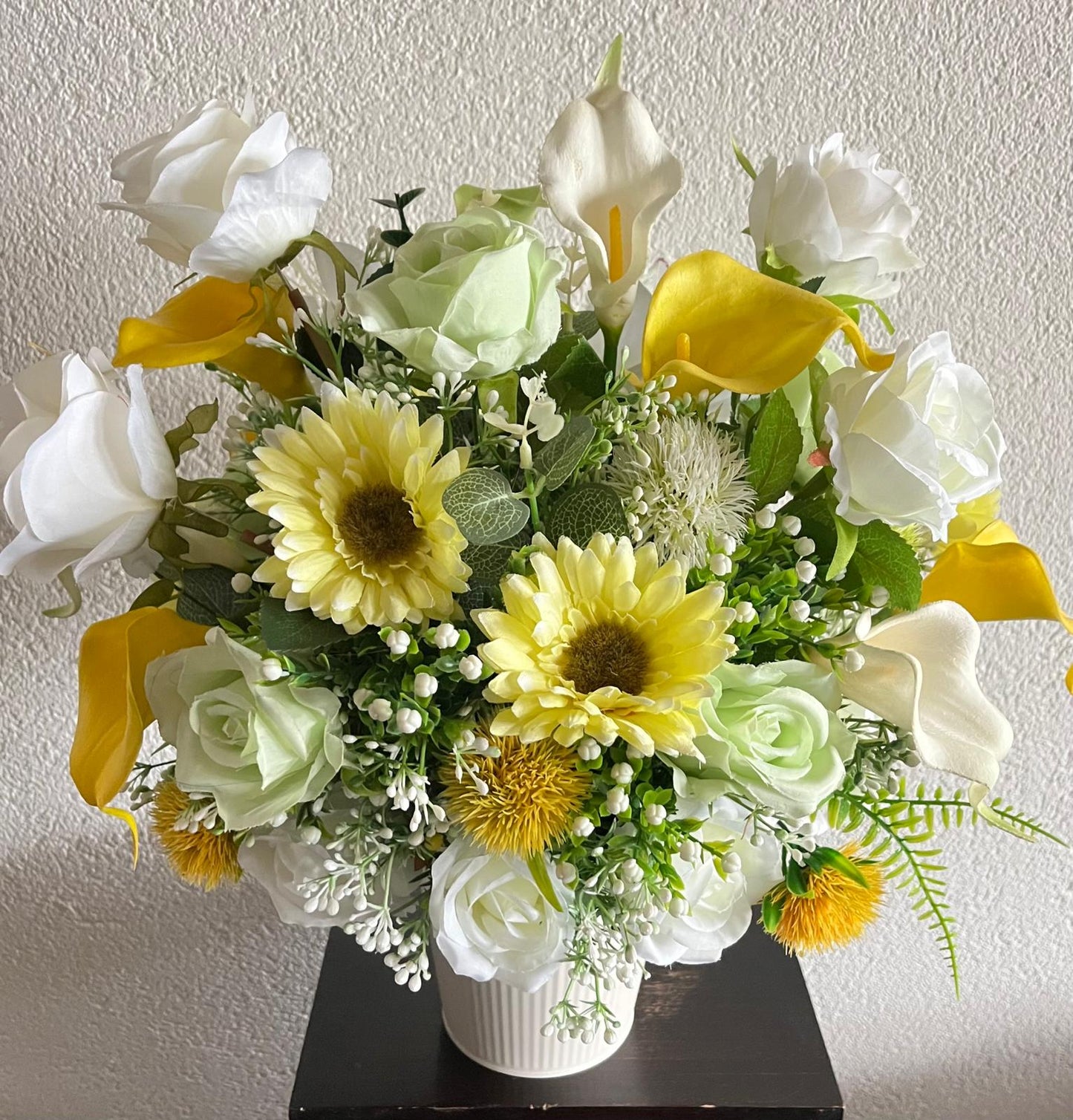 The hanging bucket with the yellow flowers
