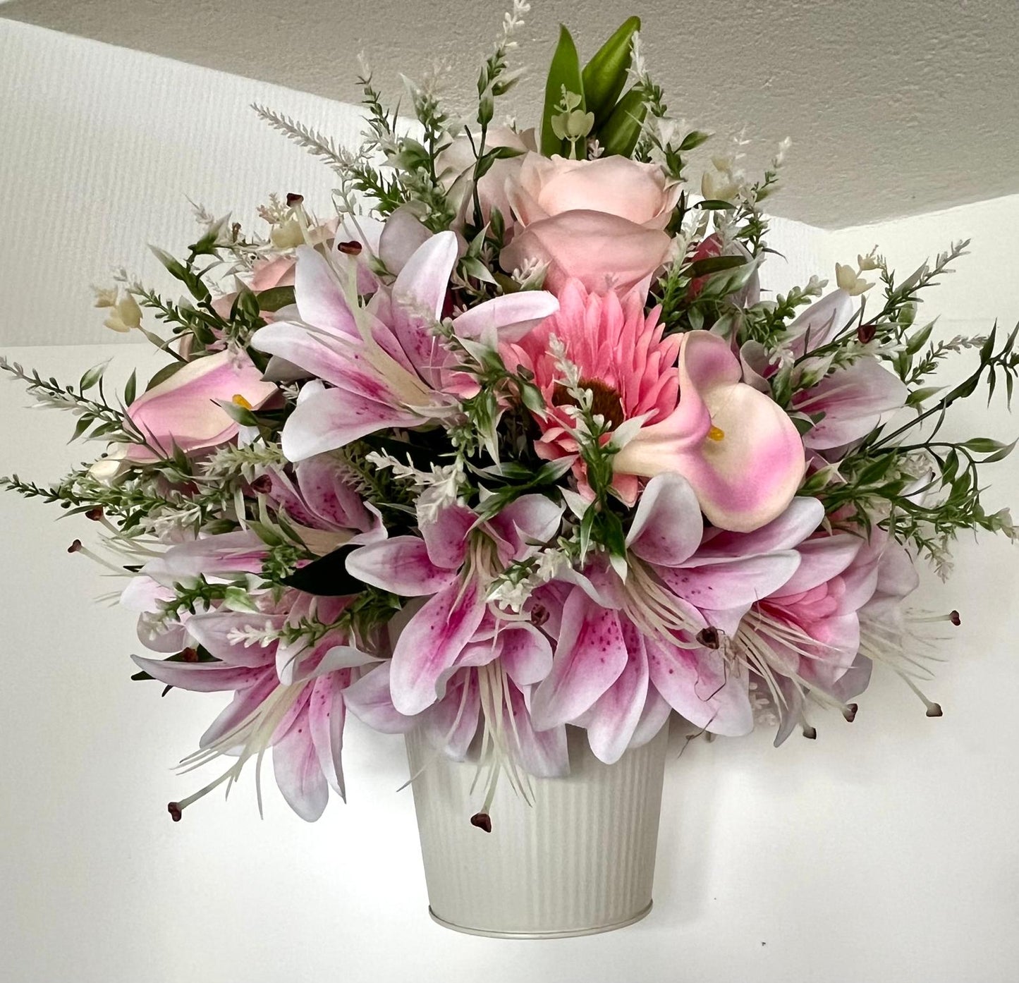 The hanging bucket with the pink lilies